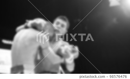 Blurred images black and white photo style of Thai boxing or Muay Thai or Kickboxing which local and foriegn boxer are fighting on the ring at indoor stage as martial art sport. Muay Thai Kick boxing Blurred images black and white photo style of Thai boxing or Muay Thai or Kickboxing which local and foriegn boxer are fighting on the ring at indoor stage as martial art sport. Muay Thai Kick boxing 98576476