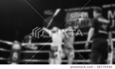Blurred images black and white photo style of Thai boxing or Muay Thai or Kickboxing which local and foriegn boxer are fighting on the ring at indoor stage as martial art sport. Muay Thai Kick boxing Blurred images black and white photo style of Thai boxing or Muay Thai or Kickboxing which local and foriegn boxer are fighting on the ring at indoor stage as martial art sport. Muay Thai Kick boxing 98576480