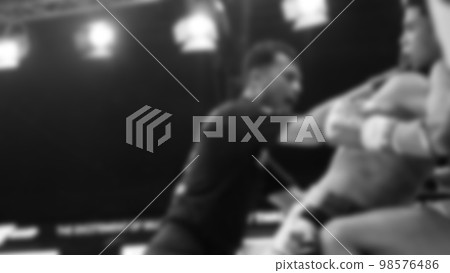 Blurred images black and white photo style of Thai boxing or Muay Thai or Kickboxing which local and foriegn boxer are fighting on the ring at indoor stage as martial art sport. Muay Thai Kick boxing Blurred images black and white photo style of Thai boxing or Muay Thai or Kickboxing which local and foriegn boxer are fighting on the ring at indoor stage as martial art sport. Muay Thai Kick boxing 98576486