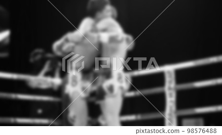 Blurred images black and white photo style of Thai boxing or Muay Thai or Kickboxing which local and foriegn boxer are fighting on the ring at indoor stage as martial art sport. Muay Thai Kick boxing Blurred images black and white photo style of Thai boxing or Muay Thai or Kickboxing which local and foriegn boxer are fighting on the ring at indoor stage as martial art sport. Muay Thai Kick boxing 98576488
