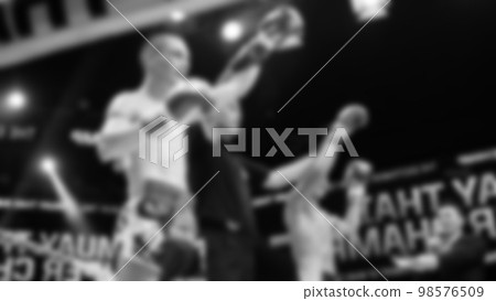 Blurred images black and white photo style of Thai boxing or Muay Thai or Kickboxing which local and foriegn boxer are fighting on the ring at indoor stage as martial art sport. Muay Thai Kick boxing Blurred images black and white photo style of Thai boxing or Muay Thai or Kickboxing which local and foriegn boxer are fighting on the ring at indoor stage as martial art sport. Muay Thai Kick boxing 98576509