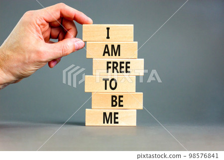 I am free to be me symbol. Concept words I am free to be me on wooden blocks on a beautiful grey table grey background. Businessman hand. Business i am free to be me concept. I am free to be me symbol. Concept words I am free to be me on wooden blocks on a beautiful grey table grey background. Businessman hand. Business i am free to be me concept. 98576841
