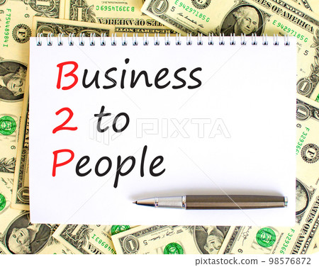 B2P business to people symbol. Concept words B2P business to people on white white note on a beautiful background from dollar bills. Business and B2P business to people concept. Copy space. B2P business to people symbol. Concept words B2P business to people on white white note on a beautiful background from dollar bills. Business and B2P business to people concept. Copy space. 98576872
