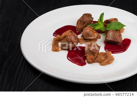 Pork meat with berries sauce 98577214