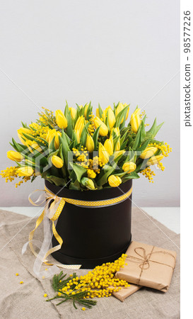 Bouquet of yellow tulips and mimosa flowers 98577226