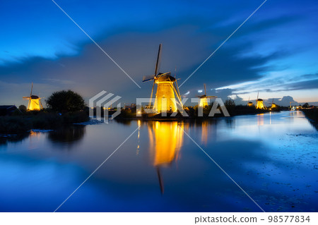 Kinderdijk National Park in the Netherlands. Windmills at dusk. UNESCO World Heritage Site. 98577834