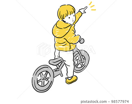 A boy riding a strider and pointing 98577974