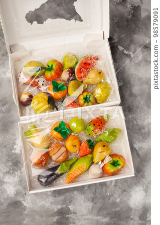 Marzipan sweets in form of fruits and vegetables in boxes Marzipan sweets in form of fruits and vegetables in boxes 98579091
