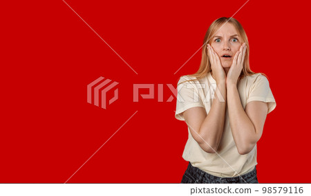 Shocked concerned young Caucasian girl look empathy camera, gasping open mouth worried, frowning upset hear frustrating news, feel sorry for friend, touch cheeks speechless, stand red background Shocked concerned young Caucasian girl look empathy camera, gasping open mouth worried, frowning upset hear frustrating news, feel sorry for friend, touch cheeks speechless, stand red background 98579116