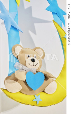 A children's toy made of felt. A teddy bear made of fabric. Creativity with children. DIY projects with your own hands. Crafts. A children's toy made of felt. A teddy bear made of fabric. Creativity with children. DIY projects with your own hands. Crafts. 98579394