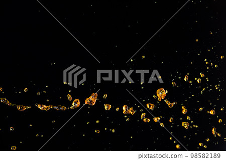 Orange, lemon juice or oil lubricant splash, liquid gold yellow drink drops. Fruit beverage water elements in line form . Fresh splashing and flowing jets, black background isolated freeze motion 98582189