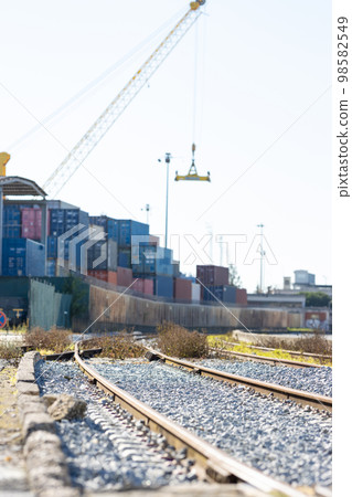 Railways near the warehouse with a bunch of containers in the open air 98582549