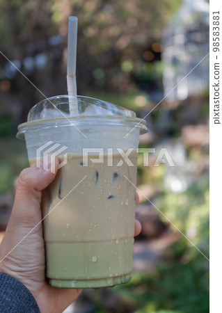 Woman hold her iced coffee 98583881