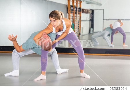 Girl practicing effective self defence techniques in training room Girl practicing effective self defence techniques in training room 98583934