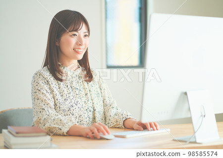 Woman working remotely Woman working remotely 98585574