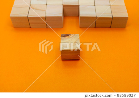 Orange background with knotty wood cubes in the foreground in one of the mountains Orange background with knotty wood cubes in the foreground in one of the mountains 98589027