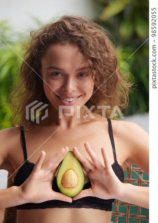 Smiling Woman Holding Avocado. Beautiful Happy Woman With Smooth Soft Clean Skin 98592055