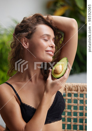 Smiling Woman Holding Avocado. Beautiful Happy Woman With Smooth Soft Clean Skin 98592065