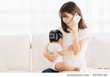 Mother calling the hospital with her sick baby Mother calling the hospital with her sick baby 98593190