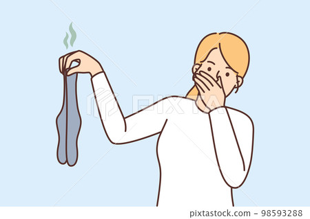 Woman disgusted with smelly dirty socks  98593288