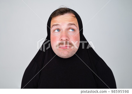 Funny caucasian man covering head with sweater smiling cheerful and funny. Funny caucasian man covering head with sweater smiling cheerful and funny. 98595598