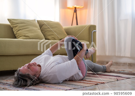 Fitness woman doing stretch exercise stretching her body.  98595609