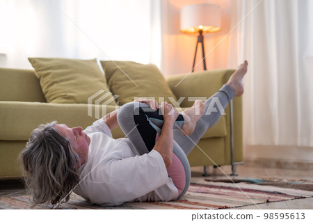 Fitness woman doing stretch exercise stretching her body. Fitness woman doing stretch exercise stretching her body. 98595613