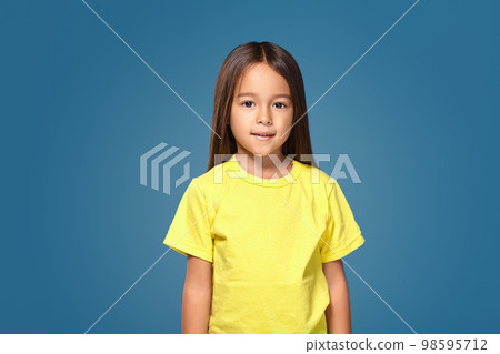 Little girl is smiling in yellow t-shirt Little girl is smiling in yellow t-shirt 98595712