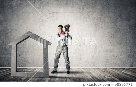 Stone home silhouette in empty room as symbol for real estate insurance Stone home silhouette in empty room as symbol for real estate insurance 98595771