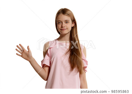 Studio portrait of a beautiful girl blonde teenager in a pink t-shirt posing isolated on white background. Studio portrait of a beautiful girl blonde teenager in a pink t-shirt posing isolated on white background. 98595863