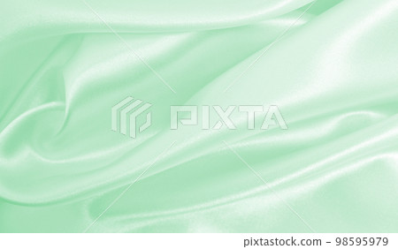 Smooth elegant green silk or satin luxury cloth texture as abstract background. Luxurious background design Smooth elegant green silk or satin luxury cloth texture as abstract background. Luxurious background design 98595979