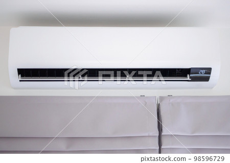 Air conditioner on white wall room interior background Air conditioner on white wall room interior background 98596729