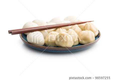 Xiaolongbao, traditional steamed dumplings on plate. Xiao Long Bao buns isolated on white background. Xiaolongbao, traditional steamed dumplings on plate. Xiao Long Bao buns isolated on white background. 98597255