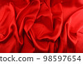 Red silk fabric background closeup 98597654