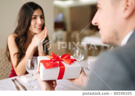 Valentine's Day concept. Happy couple in love. Couple celebrating Valentine's Day in restaurant. Valentine's Day concept. Happy couple in love. Couple celebrating Valentine's Day in restaurant. 98599105