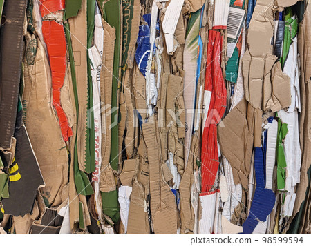 Waste paper from pressed cardboard boxes is sorted and packed for recycling 98599594
