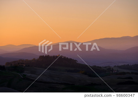 Sunrise in the typical Tuscan hills with cypresses, vineyards and house, Tuscany, Volterra, Italy Sunrise in the typical Tuscan hills with cypresses, vineyards and house, Tuscany, Volterra, Italy 98600347