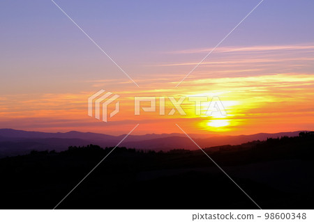 Sunset in the typical Tuscan hills with cypresses, vineyards and house, Tuscany, Volterra, Italy Sunset in the typical Tuscan hills with cypresses, vineyards and house, Tuscany, Volterra, Italy 98600348