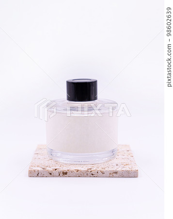 Wooden aroma sticks in a glass flask filled with flavor liquid substance isolated over white background, side view  98602639