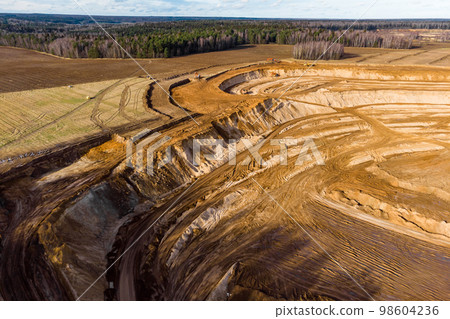 Aerial view of a growing sand pit at the expense of fields Aerial view of a growing sand pit at the expense of fields 98604236