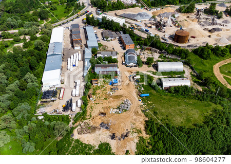 Aerial view of the industrial area with hangars outside the city Aerial view of the industrial area with hangars outside the city 98604277