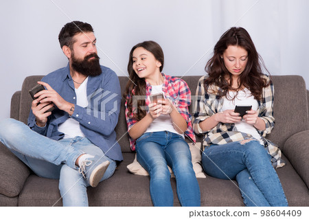 Smartphone game addiction. Family play mobile game at home. Online game playing. Gaming and entertainment. Video game. New technology. Modern life. Escape from reality 98604409