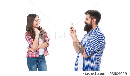 Smile for the camera. Girl child with booth glasses poses for smartphone. Smartphone photography Smile for the camera. Girl child with booth glasses poses for smartphone. Smartphone photography 98604629