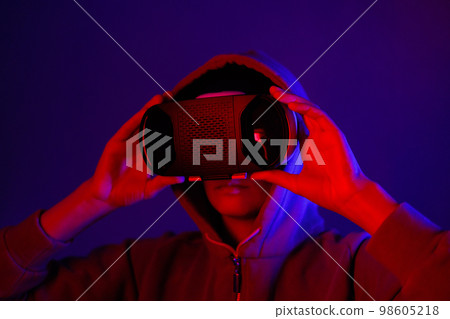 person wearing virtual reality glasses gets experience of gaming and entertainment person wearing virtual reality glasses gets experience of gaming and entertainment 98605218