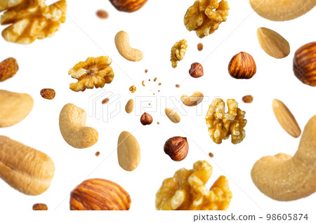 Collection of tasty crispy Hazelnut, Wallnut, Pecan nut, almond and sultana raisins falling isolated on white background. Concept organic diet mix. Selective focus 98605874