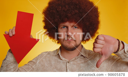 Upset bearded man showing red arrow pointing down, concept of downgrade bankruptcy money fail, fall 98605878