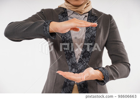 a beautiful woman with hijab standing with hands opened up and down 98606663