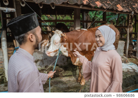 a beautiful woman in hijab looking at the moslem man and smiling a beautiful woman in hijab looking at the moslem man and smiling 98606686