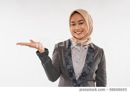 a young woman with hijab raising her opened hand on her side 98606693