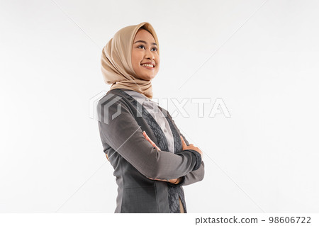 a young woman with hijab standing looking up with hand crossed 98606722